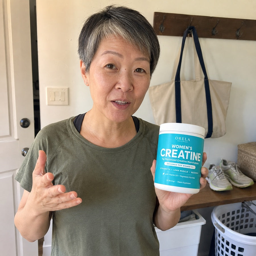 Active woman holding a jar of Orela Women’s Creatine