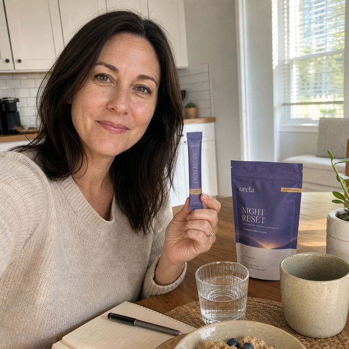 Customer holding an Orela Night Reset pouch in her kitchen