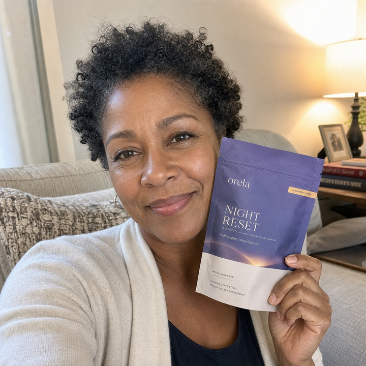 Customer holding an Orela Night Reset pouch at home