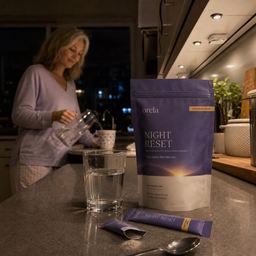 Customer holding two Orela Night Reset stick packs