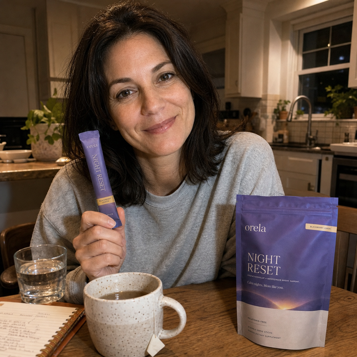 Customer holding two Orela Night Reset stick packs