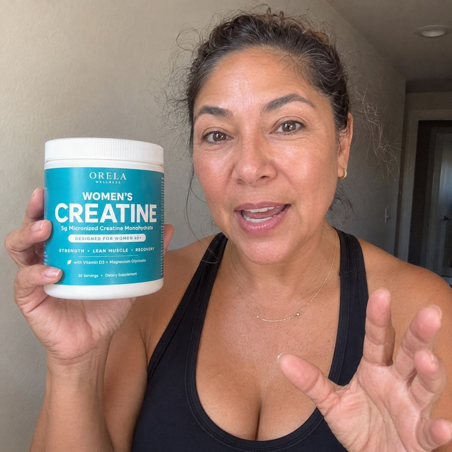 Woman holding a jar of Orela Women’s Creatine