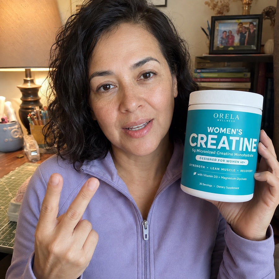 Woman in a purple jacket holding Orela Women’s Creatine