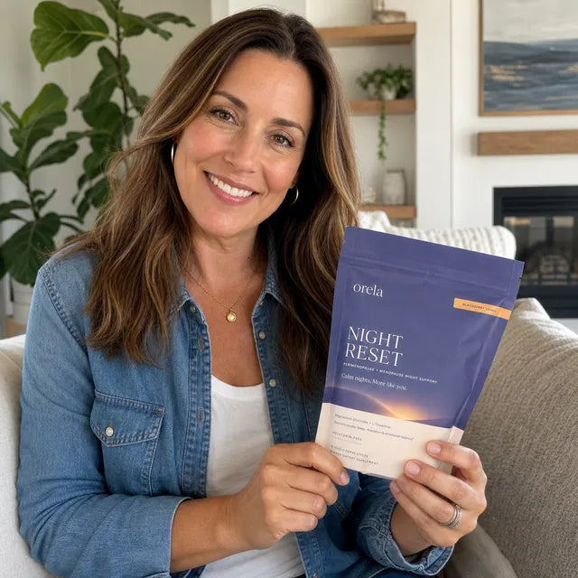 Customer smiling at home while holding an Orela Night Reset pouch