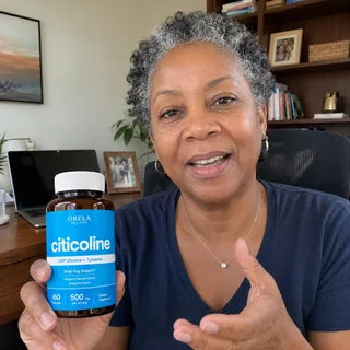 Customer holding Orela Clear Focus Citicoline in a home office